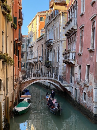 Beautiful bridge over a small canal lined, on colorful building background, Venice, Italy, during Lockdown Crisis COVID-19