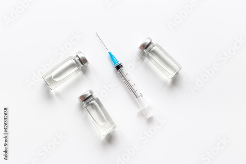 Coronavirus vaccine ampoules with syringe. Vaccination concept