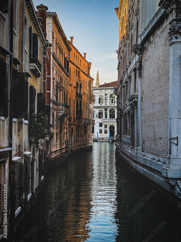 Small canal in Venice, Italy, with balcony, and, blue sky reflexion on water, no boat, no people