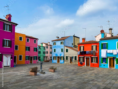 Colorful houses on a small traditional square at Burano island, Venice, Italy © Eric Isselée