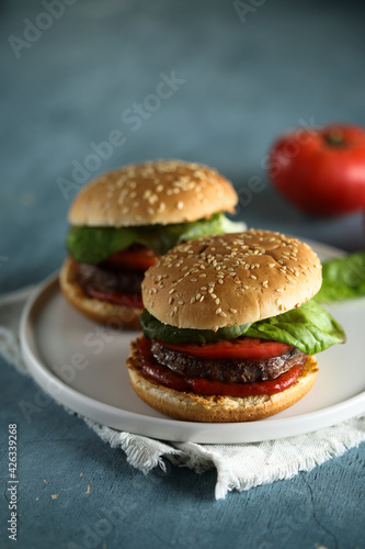 Homemade burgers with tomato and basil