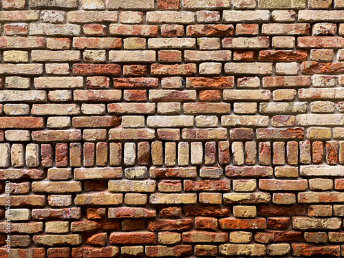 Horizontal part of a Venetian old red brick wall, background,