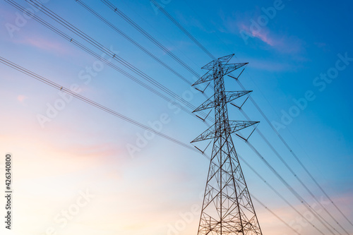 Wallpaper Mural high-voltage power lines, high voltage electric transmission tower for producing electricity at high voltage electricity poles at the sunset