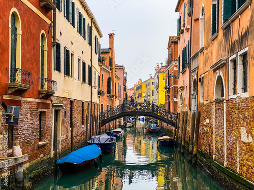 Unrecognizable person walking on a bridge in Venice, Italy