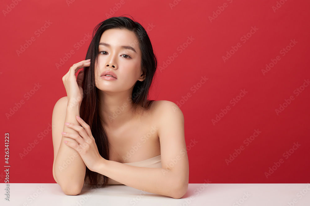 Beautiful young asian woman with clean fresh skin on red background, Face care, Facial treatment, Cosmetology, beauty and spa, Asian women portrait Beautiful young asian woman with clean fresh skin on red background, Face care, Facial treatment, Cosmetology, beauty and spa, Asian women portrait