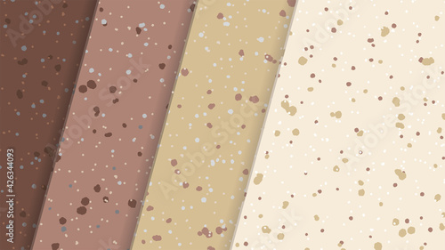 Layered abstract background paper or tiles in brown and beige colors with speckles lying on top of each other