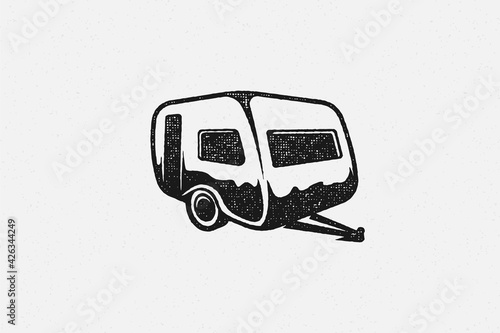 Silhouette of retro camper designed as emblem road trip in countryside hand drawn stamp effect vector illustration.