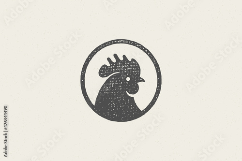 Black rooster head silhouette for poultry farm industry hand drawn stamp effect vector illustration. photo