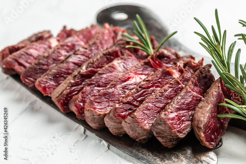 Juicy Beef rump steak from marble beef medium rare served on old meat butcher on light background, top view