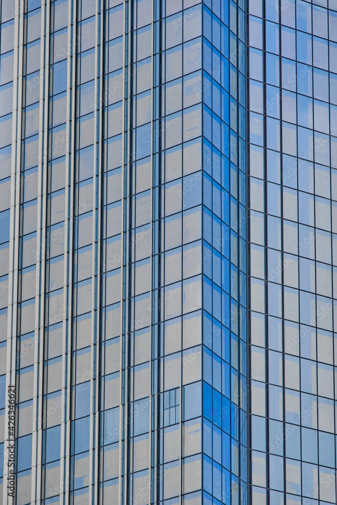The skyscraper windows are close. Beautiful blue business background The skyscraper windows are close. Beautiful blue business background
