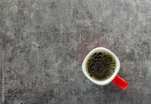 Pictured above, a bubble coffee drink in a red cup, a flavor of espresso, cappuccino, old and vintage background, is a hot morning drink to drink before breakfast with copy space for text.