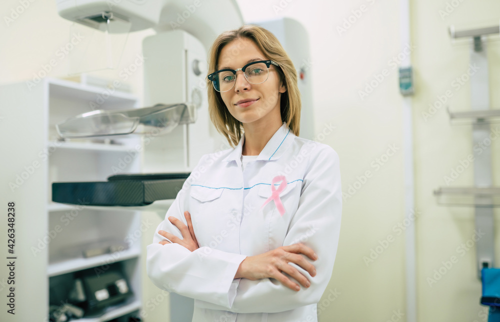 Cute professional woman doctor is working with modern Mammography X-Ray System Machine in a hospital or private clinic. Cancer and disease female treatment concept Cute professional woman doctor is working with modern Mammography X-Ray System Machine in a hospital or private clinic. Cancer and disease female treatment concept