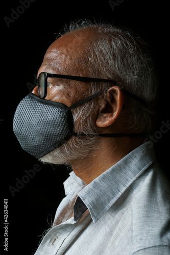 Portrait of 60 years old Indian man wearing mask (ID: 426348411)