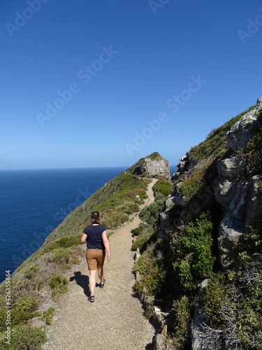 cape of good hope in south africa, a woman hiking on a path © Astrid