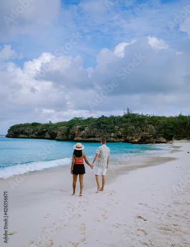 Grote knip beach Curacao, Island beach of Curacao in the Caribbean men and woman on vacation visit the beach. couple mid age men and woman on the beach Playa Knip photo