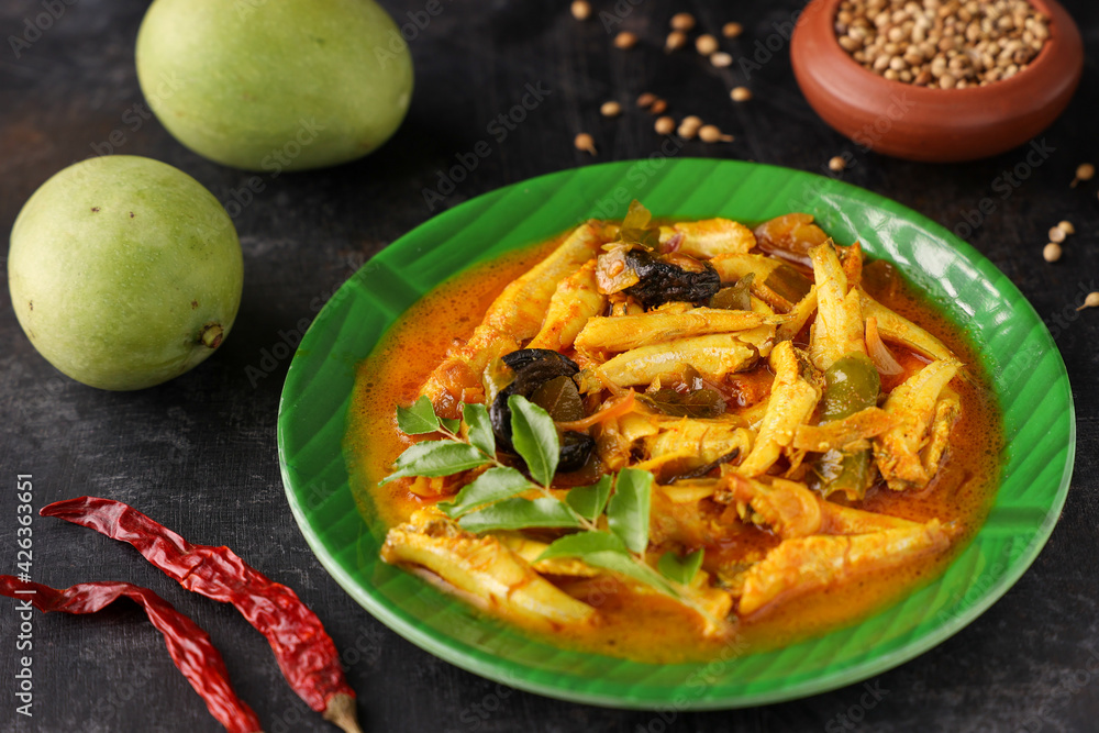 spicy hot anchovy Kerala fish curry. Indian food. Fish curry with red chili, curry leaf, coconut