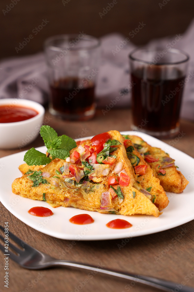 Bread omelet Indian street food with tomato sauce breakfast food non vegetarian Indian snack. snack with whole wheat bread. Protein rich kids tiffin fried egg fast food Kerala Mumbai India Sri Lanka. Bread omelet Indian street food with tomato sauce breakfast food non vegetarian Indian snack. snack with whole wheat bread. Protein rich kids tiffin fried egg fast food Kerala Mumbai India Sri Lanka.
