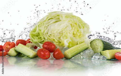 Vegetables water splash on a white background with ice cubes and crushed ice