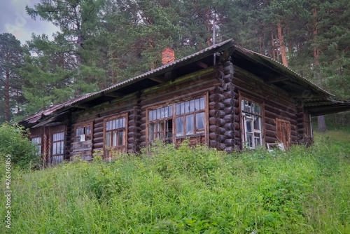 Abandoned old wooden log house in the forest.