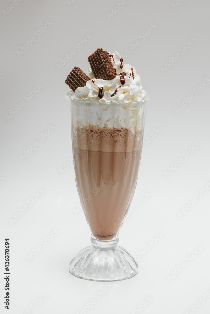 Tasty milk shake with chocolate topping on white background Tasty milk shake with chocolate topping on white background