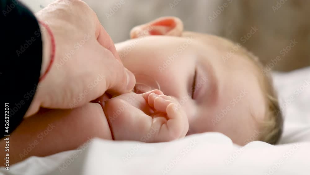 Little baby sleeping father gives by the hand. selective focus. Little baby sleeping father gives by the hand. selective focus.