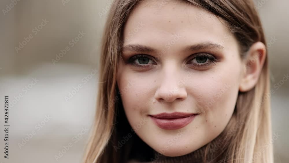 Closeup face of beautiful blond sexy smiling woman with long hair. Portrait of gorgeous girl looking to camera Closeup face of beautiful blond sexy smiling woman with long hair. Portrait of gorgeous girl looking to camera