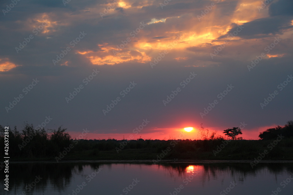 beautiful sunset at the okavango river in namibia