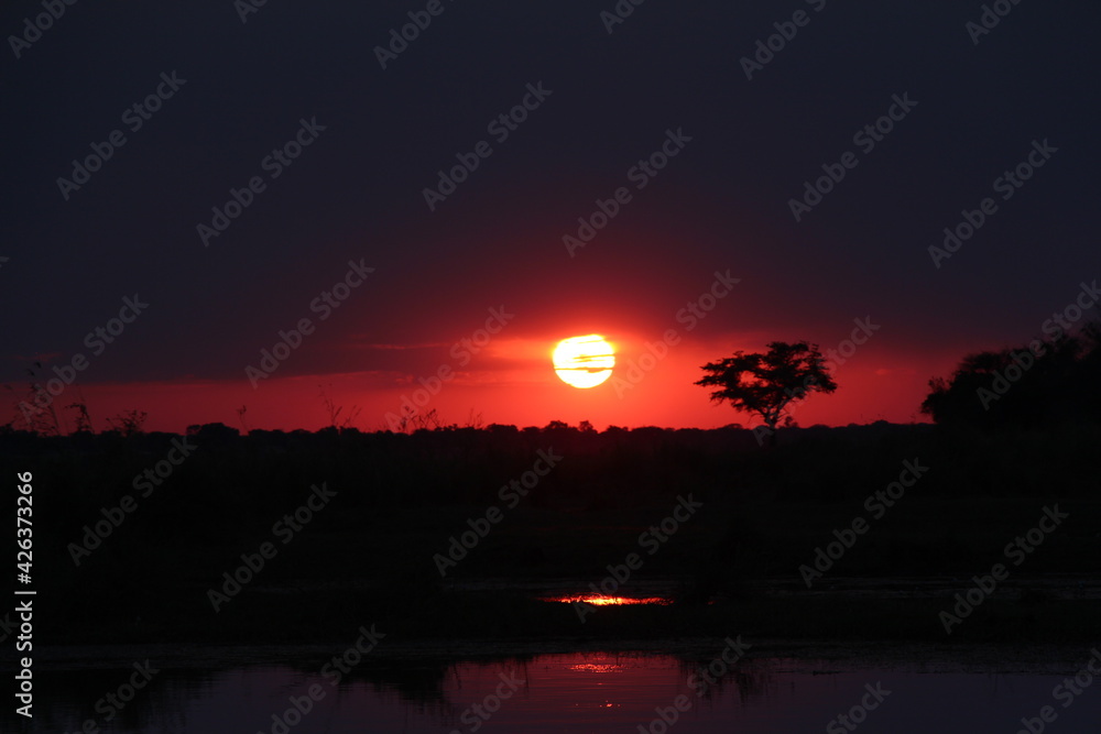 beautiful sunset at the okavango river in namibia