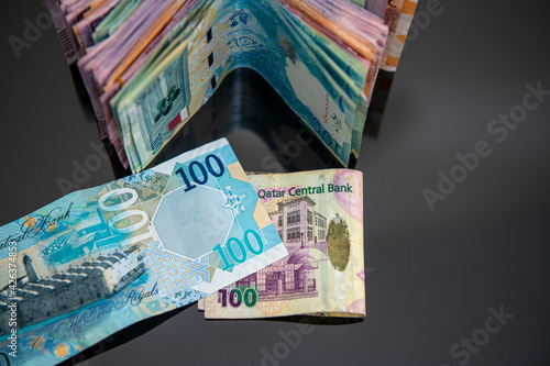 Doha, Qatar - April 08, 2021: New and old Qatri 100 Rial Bank Note.  photo