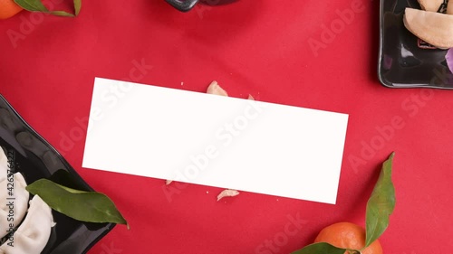 The Opens traditional wish cookie is spinning in the center. Prediction of the future in the Chinese new year and typical food for the holiday on a red background. Stop motion. FullHD footage