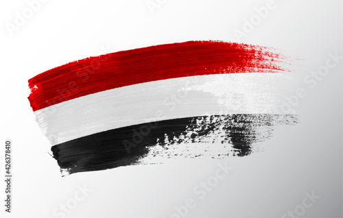 Yemen flag illustrated on paint brush stroke
