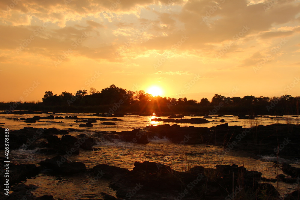 Naklejka premium beautiful sunset at the okavango river in namibia