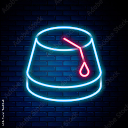 Glowing neon line Turkish hat icon isolated on brick wall background. Colorful outline concept. Vector