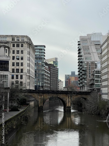 A river running through Manchester City centre with modern architecture and landmark buildings.  © ReayWorld