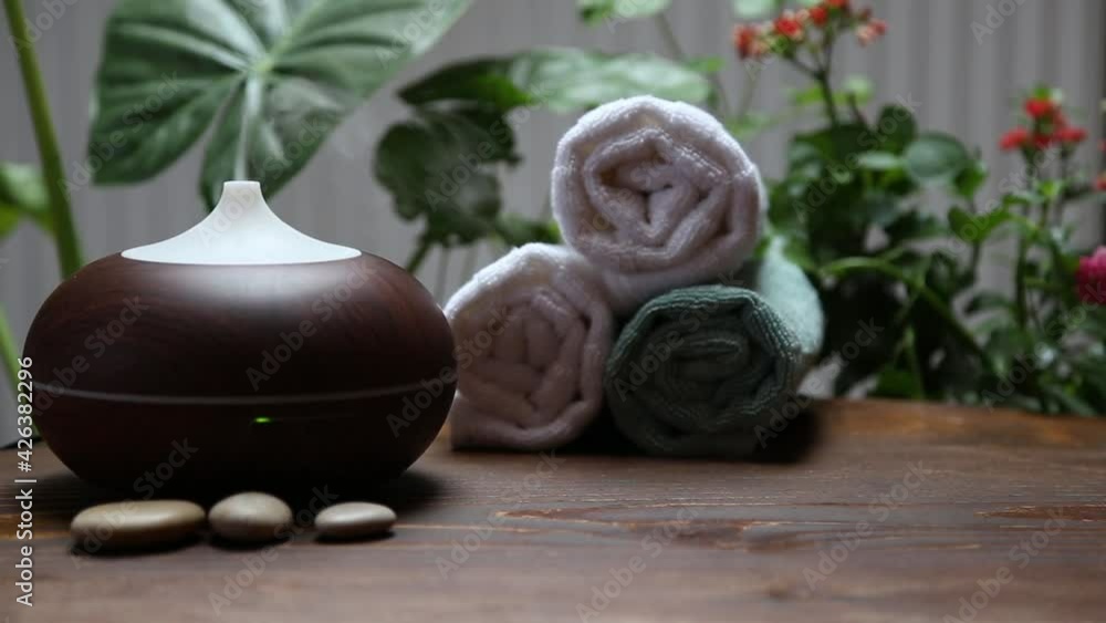 Spa background setting with aromatherapy diffuser and bath towels, wellness and spa Spa background setting with aromatherapy diffuser and bath towels, wellness and spa