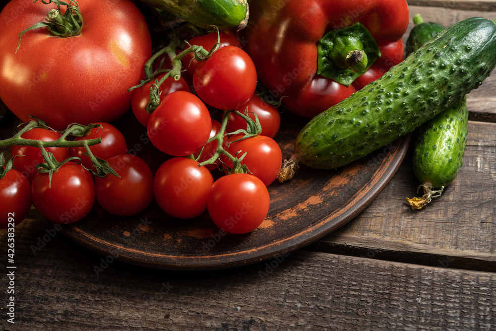 Multiple fresh organic vegetables on a wooden background Multiple fresh organic vegetables on a wooden background