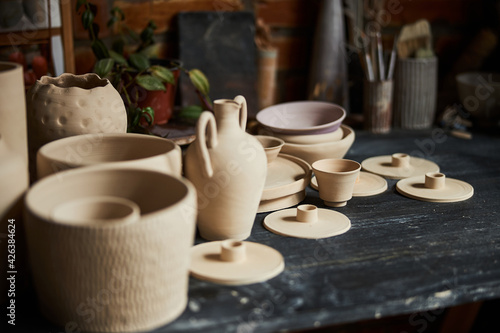 Collection of handmade pottery on table in workshop