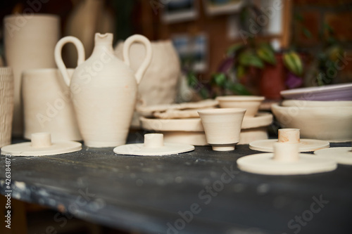 Collection of handmade pottery on table in workshop