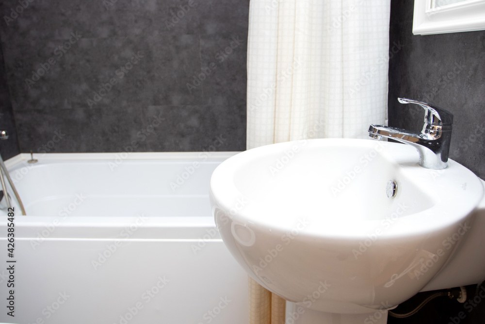 Fototapeta premium Bathroom sink and faucet in modern bathroom interior. Washbasin and bath