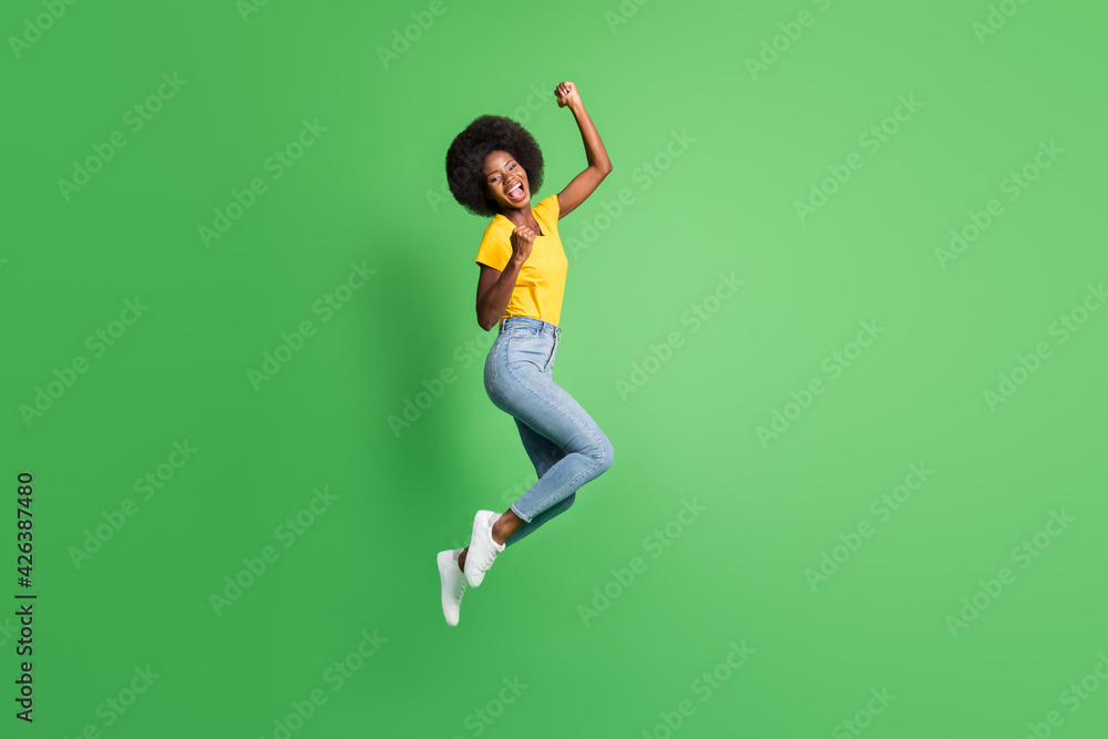 Full length body size photo of jumping girl gesturing like winner happy isolated on bright green color background