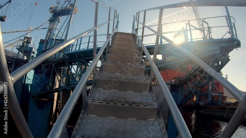 Walking up steel gangway ladder to shipyards drydock photo