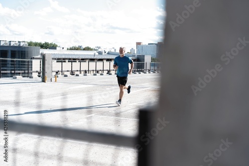 Fitness, workout, sport, lifestyle concept. Middle-aged man running in the city