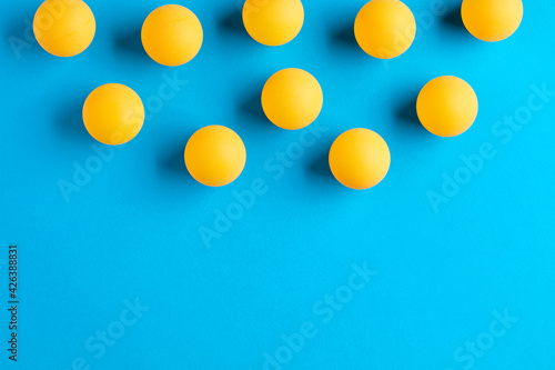 Orange table tennis or ping pong balls on blue background