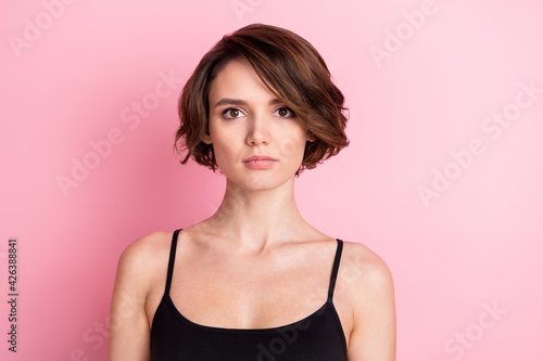 Photo of serious charming attractive young woman wear black singlet isolated on pastel pink color background
