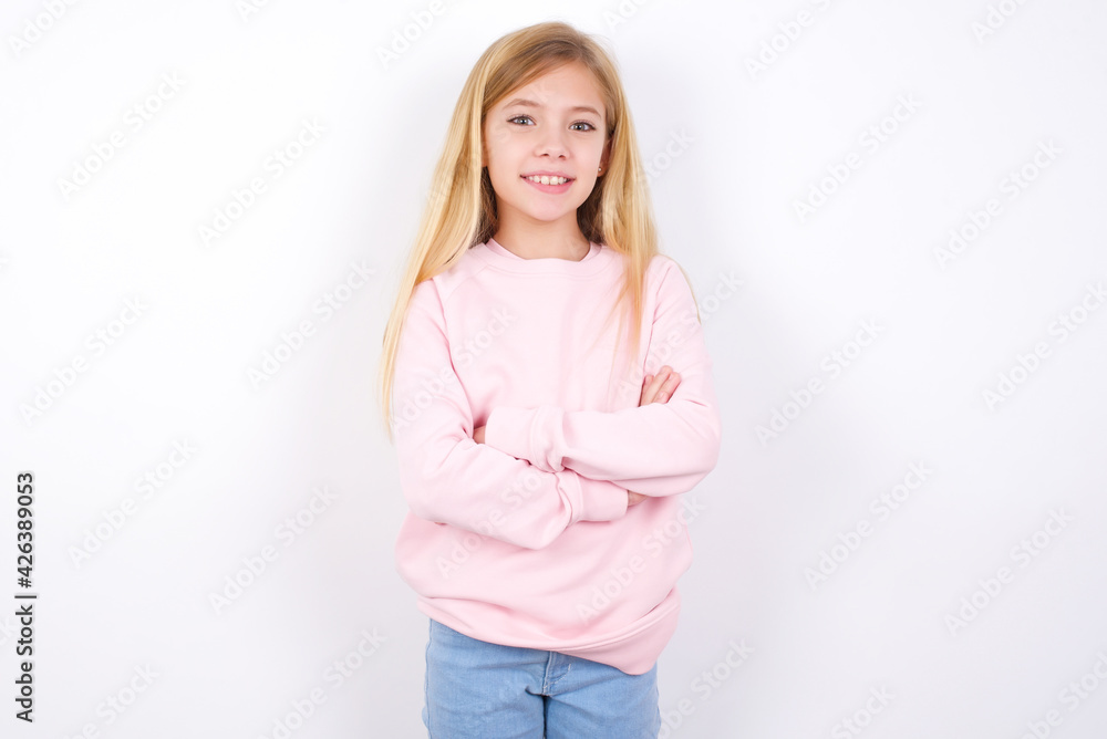 beautiful caucasian little girl wearing pink hoodie over white background being happy smiling and crossed arms looking confident at the camera. Positive and confident person. beautiful caucasian little girl wearing pink hoodie over white background being happy smiling and crossed arms looking confident at the camera. Positive and confident person.