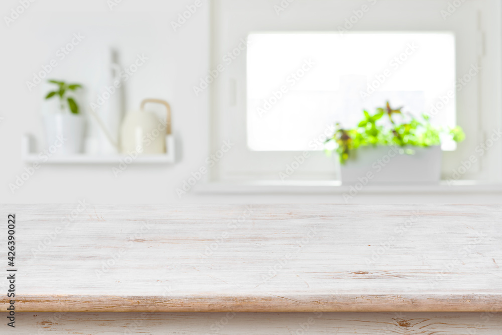 Wooden tabletop with copy space over blur kitchen window background Wooden tabletop with copy space over blur kitchen window background