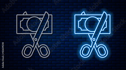 Glowing neon line Scissors cutting money icon isolated on brick wall background. Price, cost reduction or price reduction icon concept. Vector