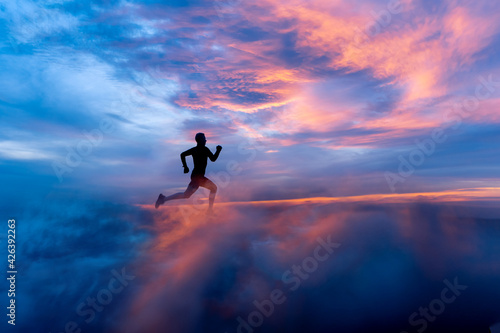 Male runner silhouette on fiery sunset backdrop