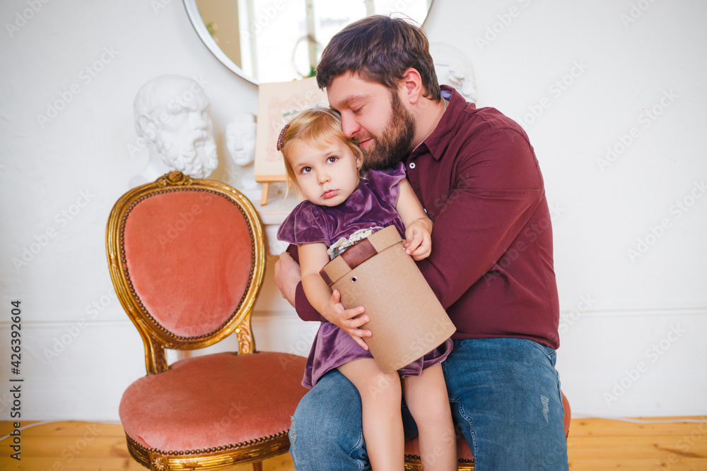 Father gives gifts to daughter for the new year. 