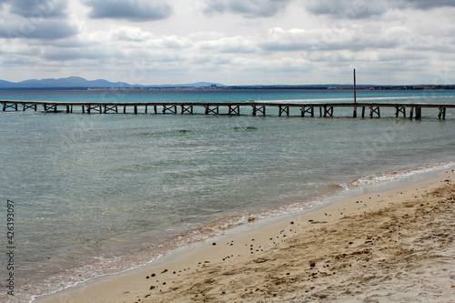 wooden pier in Alcudia popular resort on Majorca  Spain at cloudy day